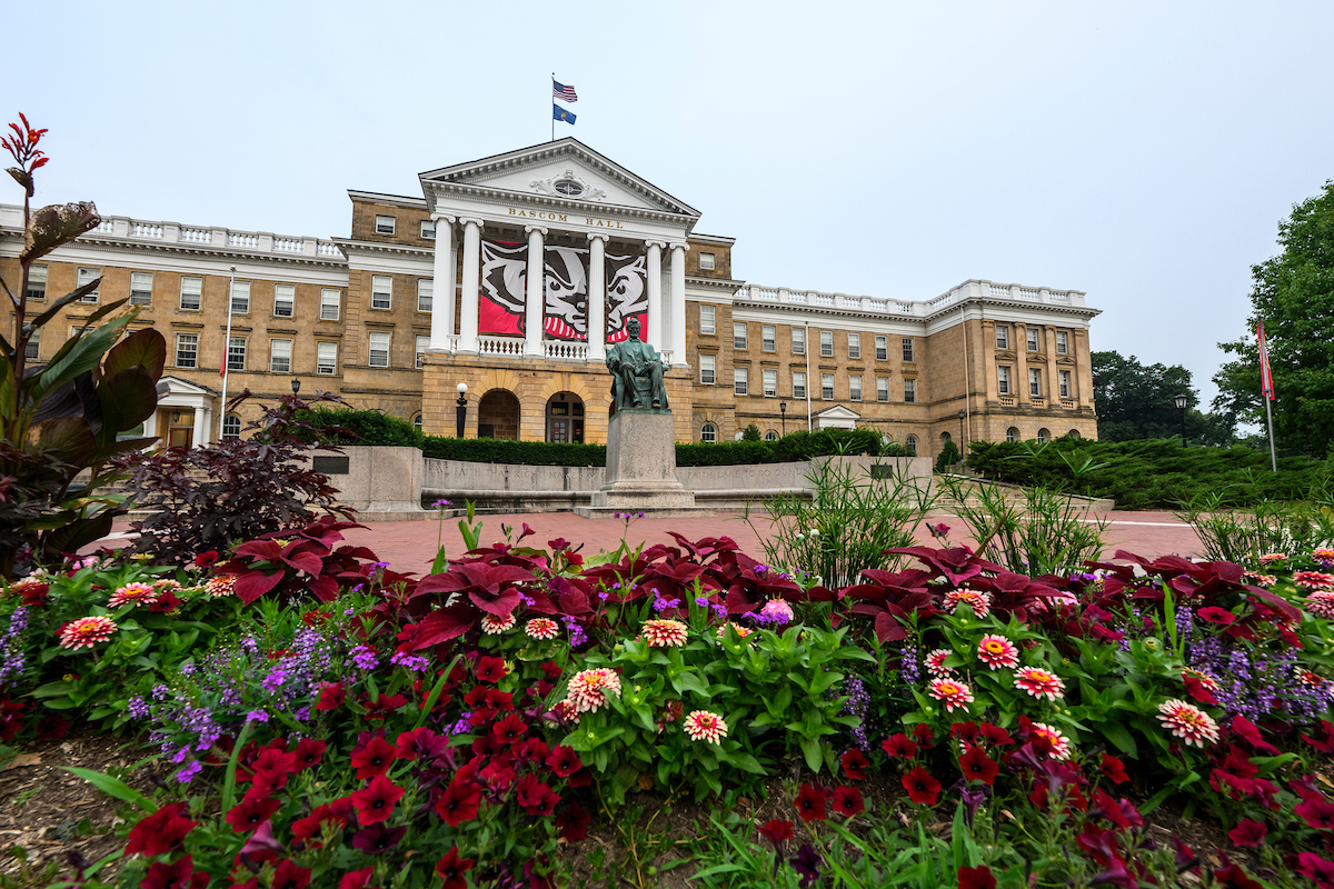 Zinnias flowers and coleus plants adorn Bascom Hall during a summer sunrise at the University of Wisconsin–Madison on July 20, 2026. (Photo by Taylor Wolfram / UW–Madison)